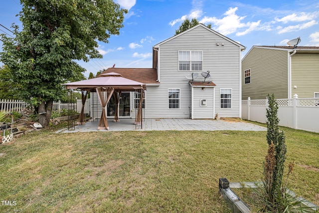 back of property with a gazebo, a lawn, a patio area, and a fenced backyard