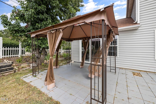 view of patio with a gazebo and fence