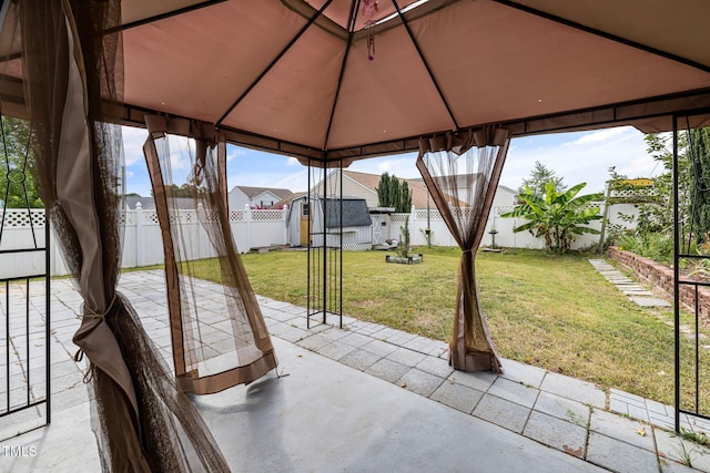 view of patio featuring a fenced backyard and a gazebo