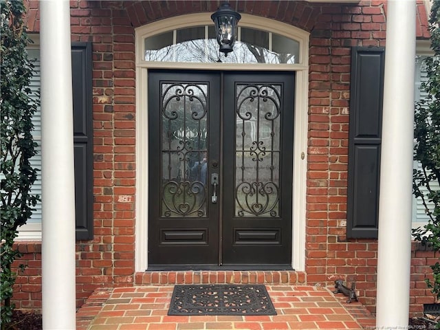 doorway to property with brick siding