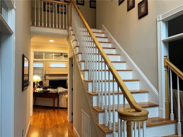 stairway featuring visible vents and wood finished floors