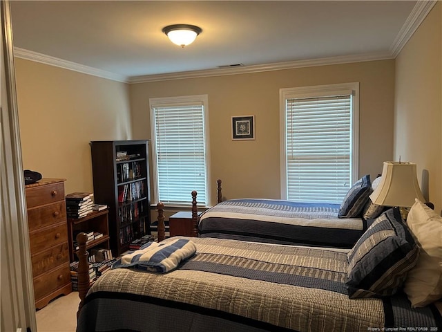 bedroom featuring ornamental molding, visible vents, and multiple windows