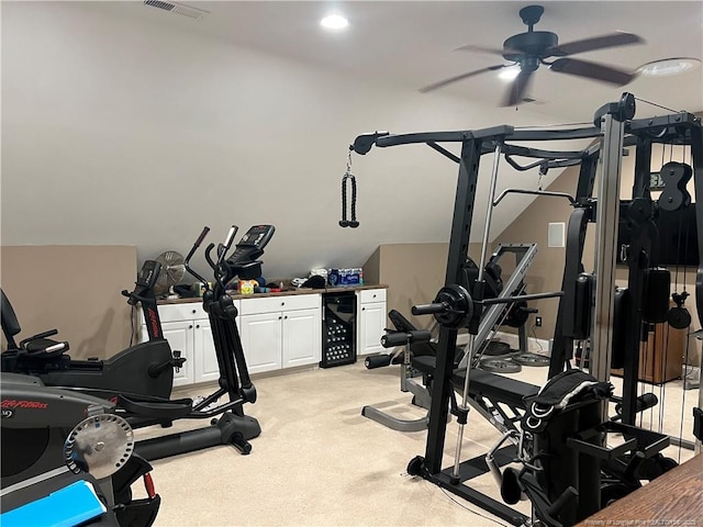 exercise area with light carpet, ceiling fan, wine cooler, and visible vents