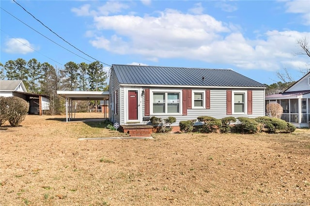 view of front of home with metal roof and a carport