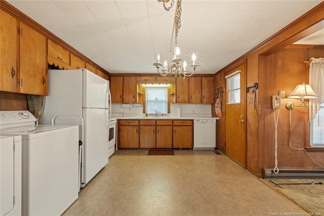 kitchen featuring a chandelier, white appliances, brown cabinetry, and a wealth of natural light