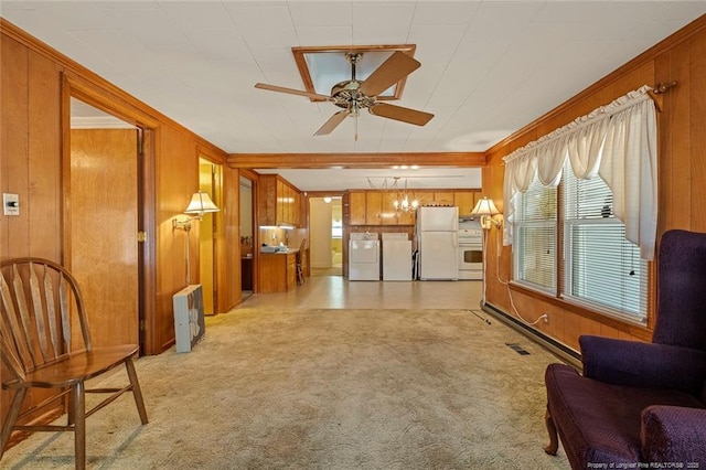 living area with washing machine and dryer, light colored carpet, wood walls, and ceiling fan