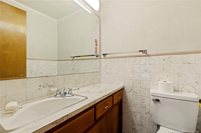 bathroom with toilet, ornamental molding, and vanity