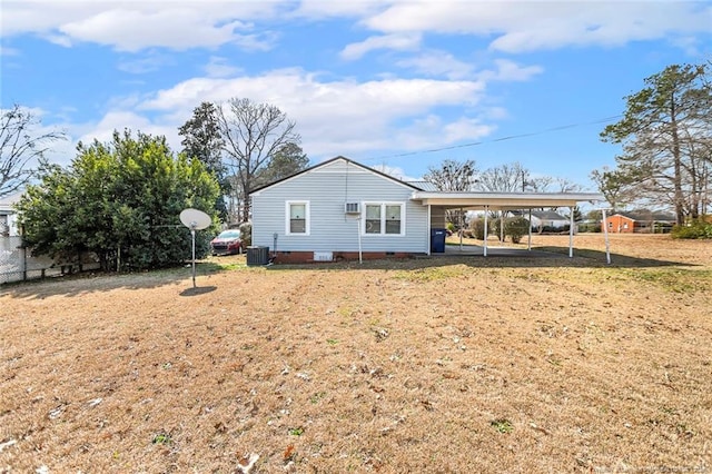 back of property with a lawn, crawl space, fence, a carport, and cooling unit