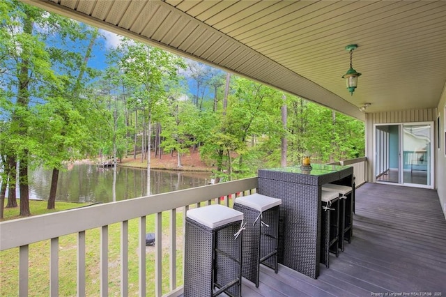 wooden terrace featuring a water view