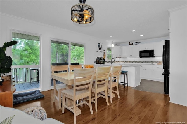 dining area featuring ornamental molding, a chandelier, dark wood-type flooring, and recessed lighting