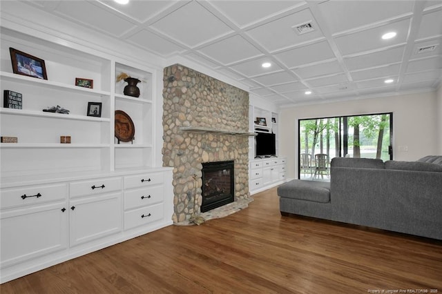 living room featuring a fireplace, coffered ceiling, visible vents, built in features, and dark wood-style floors