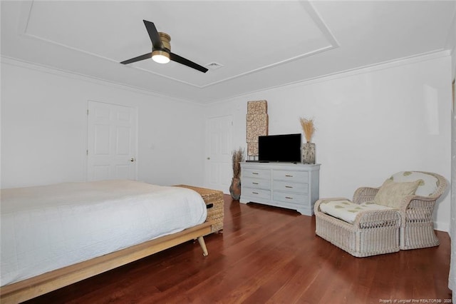 bedroom featuring ceiling fan, ornamental molding, and wood finished floors