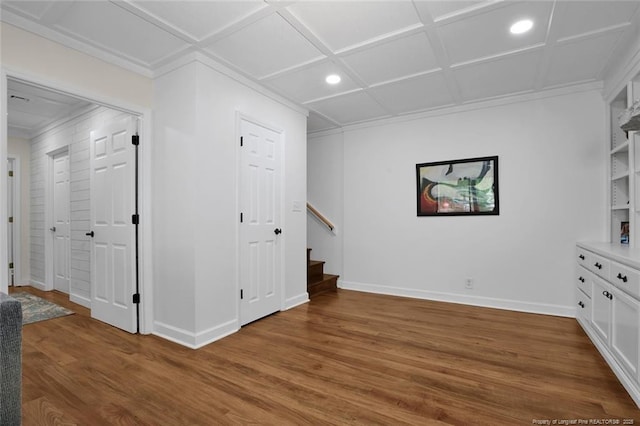 interior space with coffered ceiling, stairway, baseboards, and wood finished floors