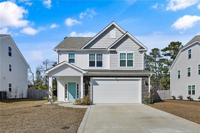 view of front of house with driveway, stone siding, an attached garage, and fence