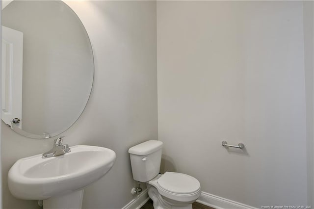 387 Springhaven Dr, Raeford, NC 28376 - half bathroom featuring baseboards, a sink, and toilet