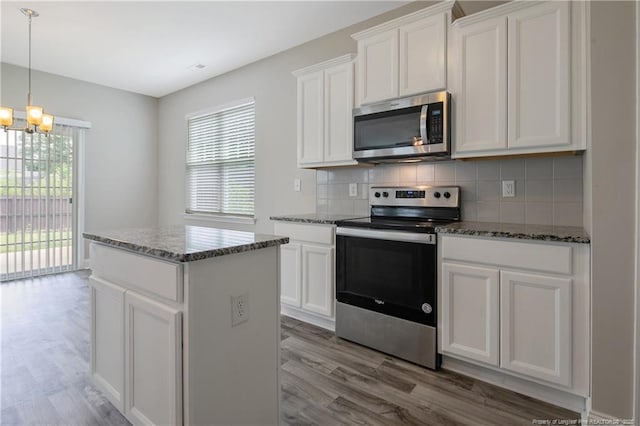 387 Springhaven Dr, Raeford, NC 28376 - kitchen featuring stainless steel appliances, a chandelier, plenty of natural light, and light wood-style floors