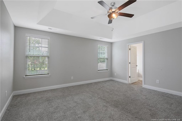 387 Springhaven Dr, Raeford, NC 28376 - carpeted spare room with a tray ceiling, plenty of natural light, a ceiling fan, and baseboards
