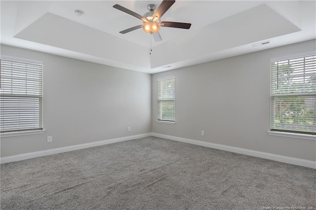 387 Springhaven Dr, Raeford, NC 28376 - unfurnished room with a raised ceiling, a ceiling fan, plenty of natural light, and baseboards