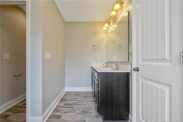 387 Springhaven Dr, Raeford, NC 28376 - bathroom featuring vanity, wood finished floors, and baseboards