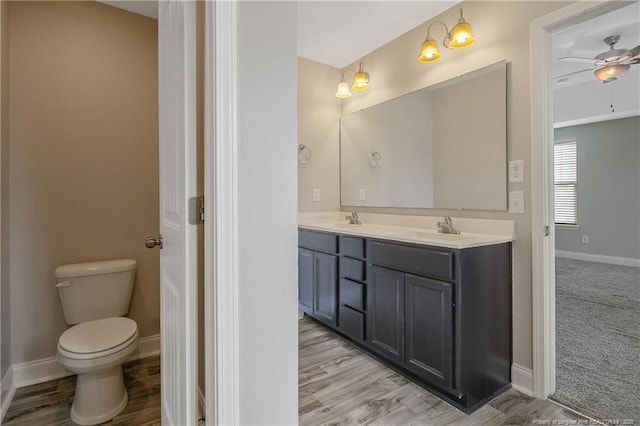 387 Springhaven Dr, Raeford, NC 28376 - full bath featuring double vanity, wood finished floors, toilet, and baseboards