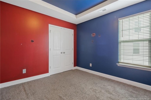 387 Springhaven Dr, Raeford, NC 28376 - unfurnished bedroom with multiple windows, carpet flooring, baseboards, and a closet