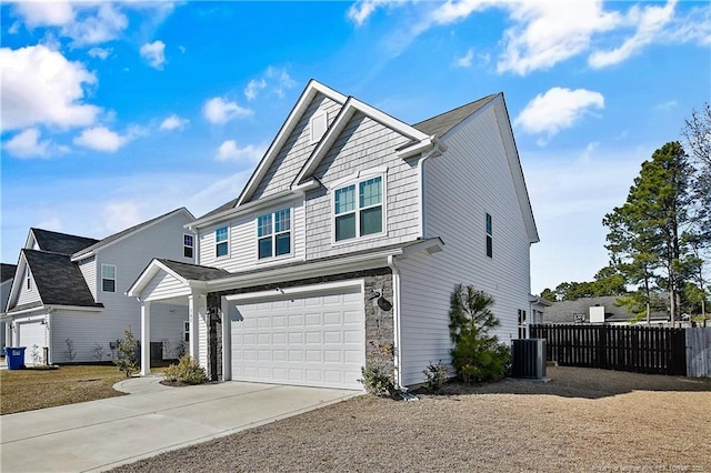 387 Springhaven Dr, Raeford, NC 28376 - view of front facade featuring an attached garage, concrete driveway, cooling unit, and stone siding