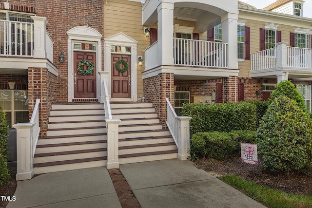 entrance to property featuring brick siding