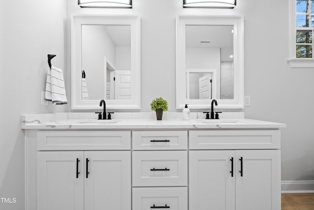 full bath with double vanity, visible vents, and a sink