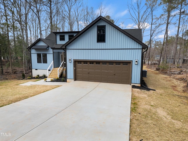 view of front of home featuring board and batten siding, driveway, and a shingled roof