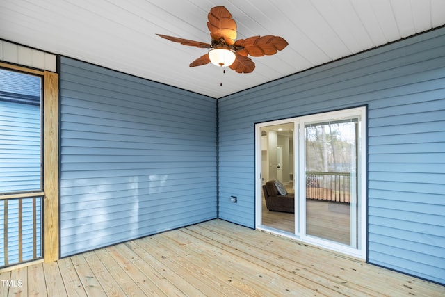 unfurnished sunroom featuring a ceiling fan