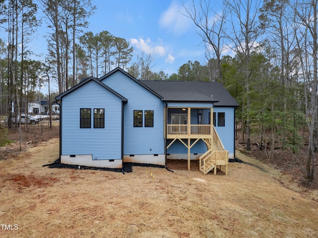 back of property with crawl space, roof with shingles, stairway, and a sunroom