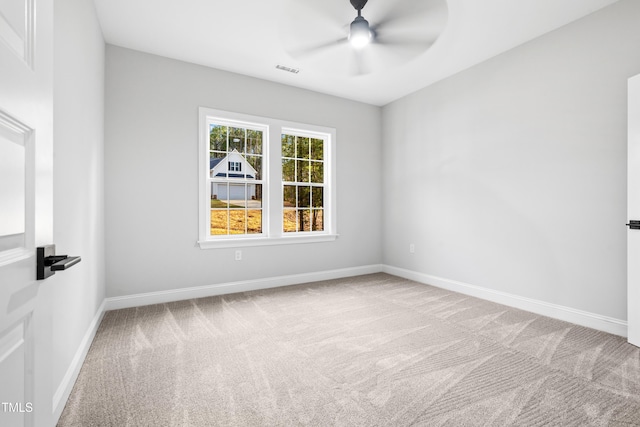 spare room with visible vents, carpet, baseboards, and ceiling fan