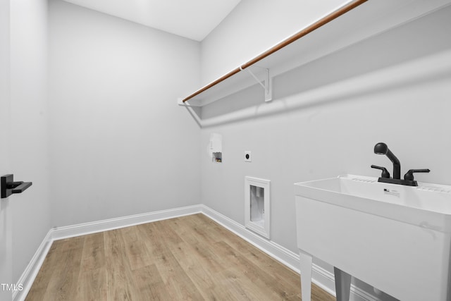 laundry room featuring electric dryer hookup, light wood-type flooring, baseboards, hookup for a washing machine, and laundry area