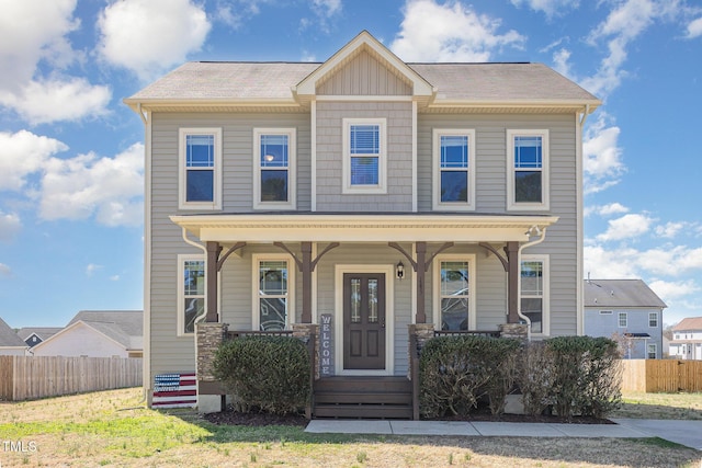 view of front of home with fence and covered porch