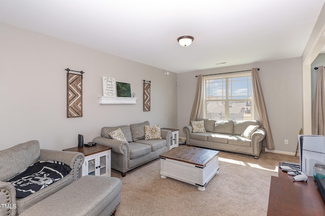 living area featuring light colored carpet and baseboards