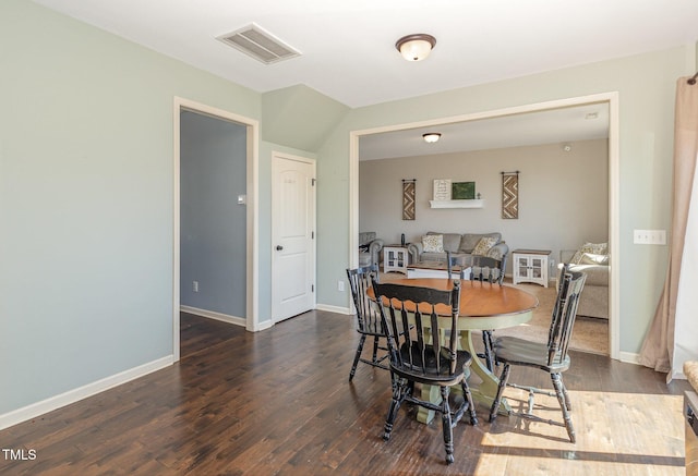 dining area featuring wood finished floors, visible vents, and baseboards