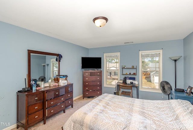 bedroom with visible vents, light carpet, and baseboards