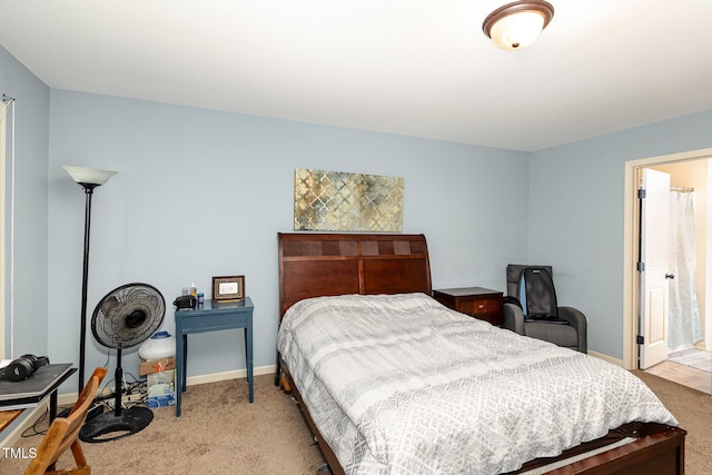 bedroom featuring light colored carpet and baseboards