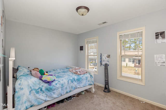 carpeted bedroom with visible vents and baseboards