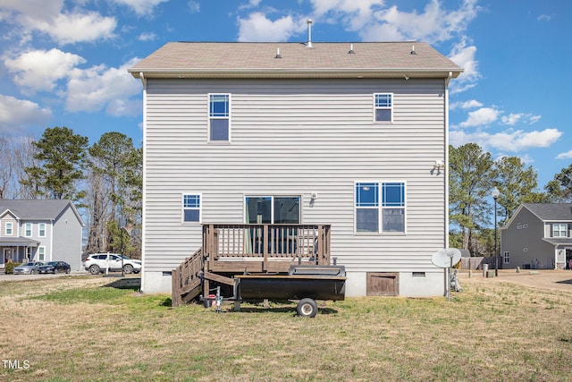 rear view of property with crawl space, a yard, and a wooden deck