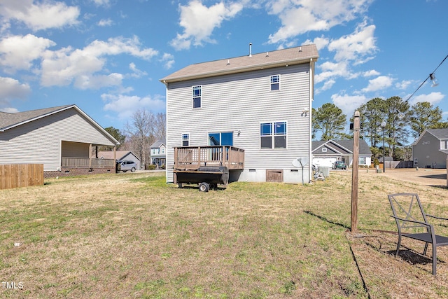 rear view of property featuring crawl space, a lawn, and a deck