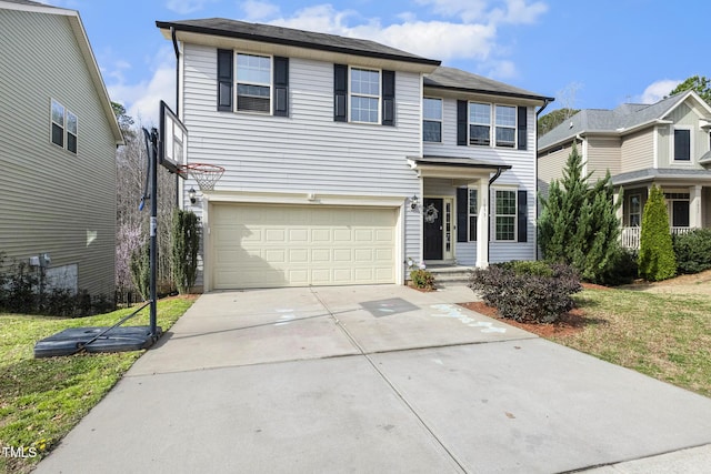 traditional-style home featuring a garage, a front lawn, and driveway