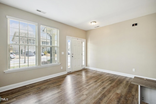 entrance foyer featuring visible vents, baseboards, and dark wood-style floors