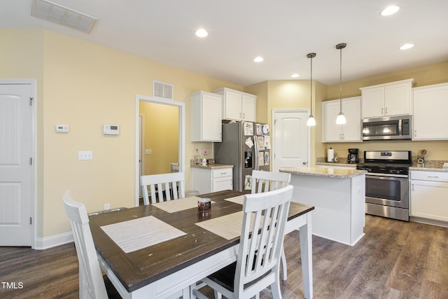 dining area featuring dark wood finished floors, visible vents, and recessed lighting