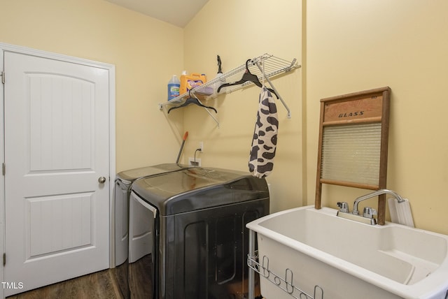 laundry area featuring a sink, independent washer and dryer, dark wood finished floors, and laundry area