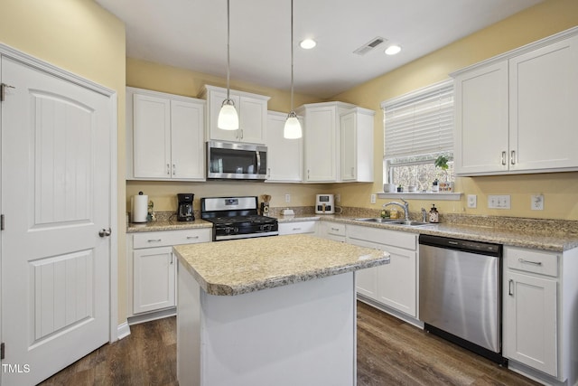 kitchen with stainless steel appliances, visible vents, and white cabinetry