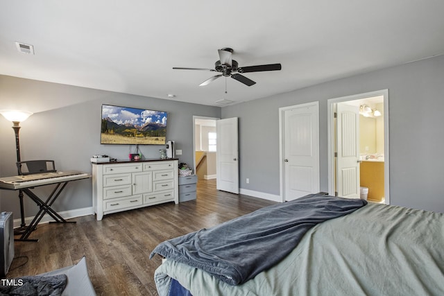 bedroom with visible vents, baseboards, dark wood-type flooring, and connected bathroom