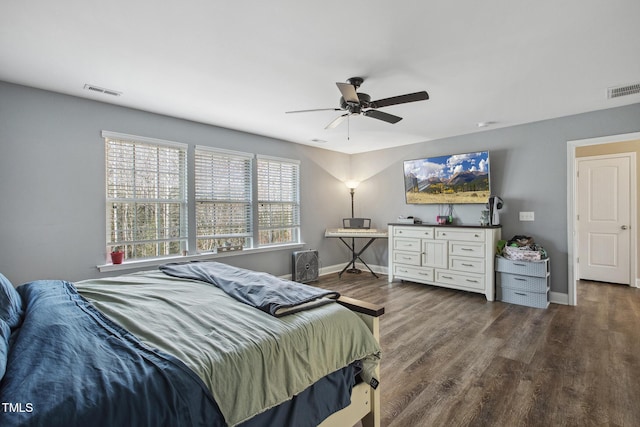 bedroom featuring ceiling fan, visible vents, baseboards, and dark wood-style floors