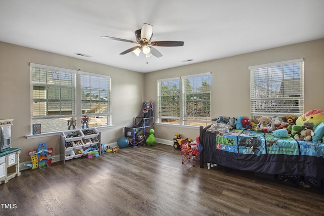 bedroom featuring visible vents, baseboards, and wood finished floors