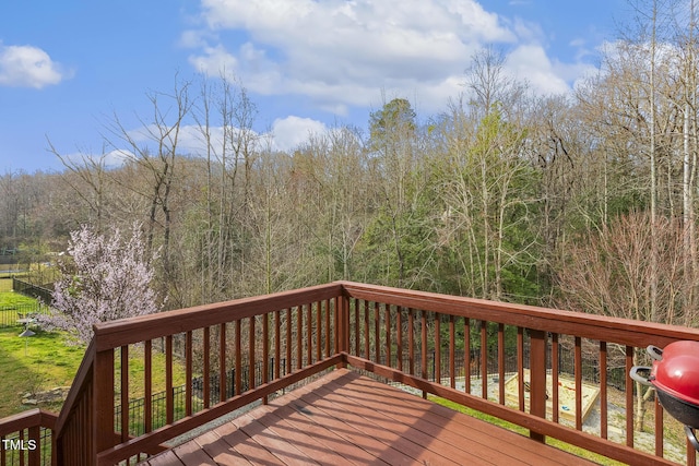 wooden deck with a view of trees